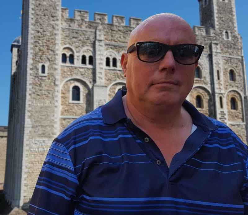 In front of the Tower of London on a bright sunny day.