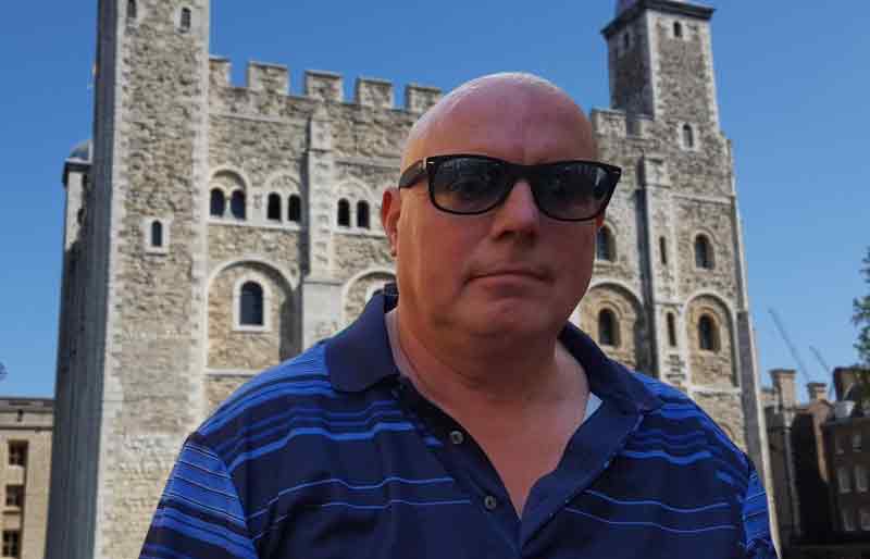 In front of the Tower of London on a bright sunny day.